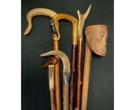 Walking stick - a club head tribal stick carved as a grimacing human head, with teeth, possibly Human, 119cm, others include 