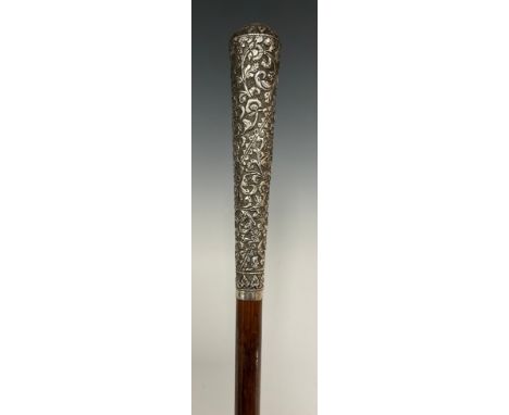 An Indian silver handled walking stick, embossed floral scrolling handle, tapering shaft with bound tip, 87cm long 