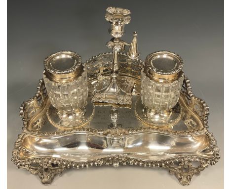 A Victorian Elkington &amp; Co inkstand, the rounded triangular base with pierced gallery back, two lidded cut glass inkwells