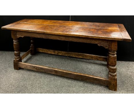 A 17th oak plank top refectory table, over sailing twin plank top, turned supports, refectory stretcher, studded ends, each e