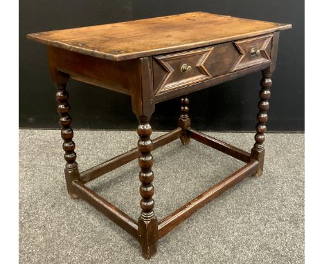 A 17th century oak side table, rectangular oversailing top above a frieze drawer applied with geometric mouldings, bobbin tur