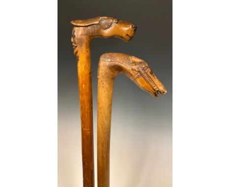 A late 19th / early 20th century Russian folk art walking stick / walking cane, the handle carved as the stylised head of a h