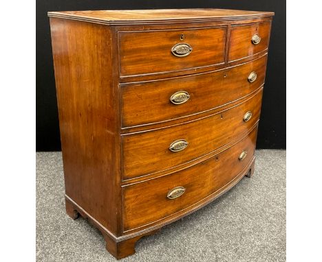 A George III mahogany bow-front chest of drawers, the satinwood cross-banded top with reeded edge, above two short, and three
