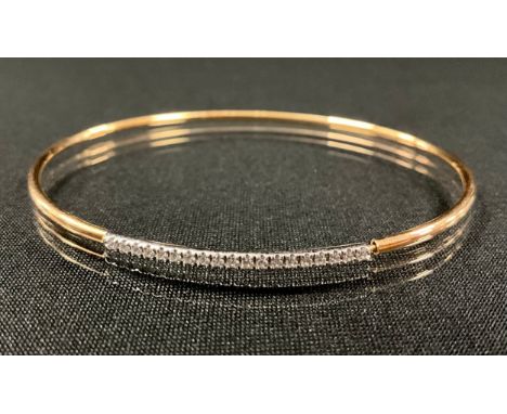 A diamond 18ct rose gold bangle, set with nineteen round brilliant cut diamonds, total diamond weight 0.17ct, 4.5g gross. 