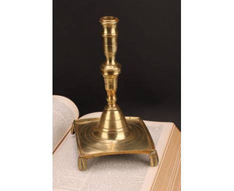 A Spanish brass tray base socket candlestick, knopped pillar, domed socle, fluted feet, 25cm high, c.1700 