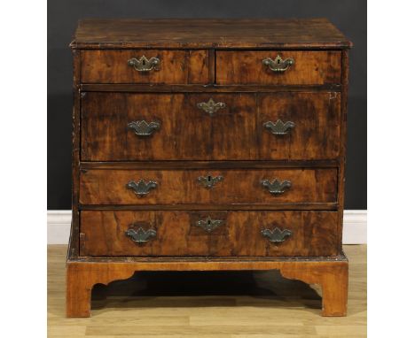 A George I walnut chest, moulded crossbanded top above two short and three long drawers, engraved brass bat shaped handles, b