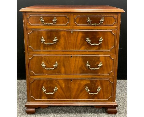A George II revival mahogany chest of drawers, over-sailing flame mahogany top, above a pair of short, and three long drawers