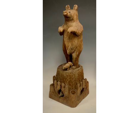 An continental early 20th century carved Bear, modelled standing front paws curled on a tree stump base, a bear cub at his fe