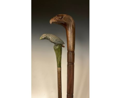 An interesting late 19th / early 20th century walking stick, the handle carved and painted as a stylised parrot, perched on a