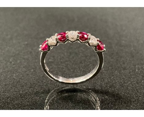 A ruby and diamond ring, alternate set with four red rubies and three round brilliant cut diamonds, total stone weights, rubi
