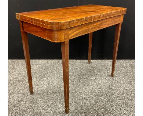 A George III mahogany card table, rounded rectangular folding top, outlined throughout with boxwood stringing, 74cm high, 91c