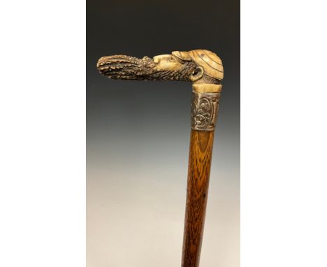An unusual late 19th or early 20th century carved walking stick / walking cane, the bone handle carved as a caricatured head 