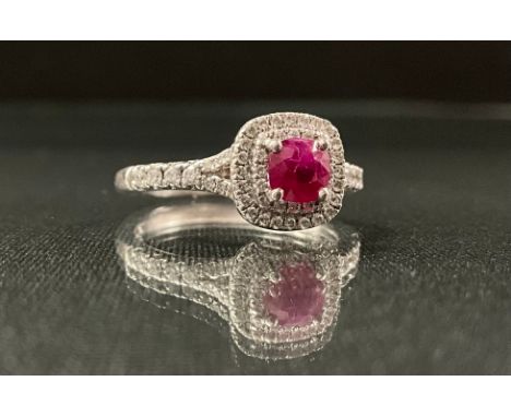 A ruby and diamond ring, cushion cut red ruby approx 0.54ct, within two tier pave diamond encrusted collar, split shoulder di