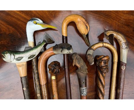 A 20th century carved wooden walking stick, by Ian Taylor, the handle realistically carved as the head of a female Mallard, 1