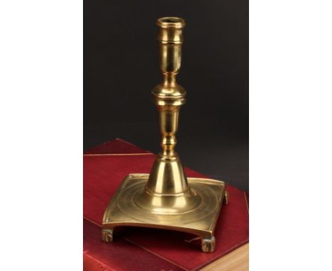 A Spanish brass tray base socket candlestick, knopped pillar, domed socle, fluted feet, 23cm high, c.1700 