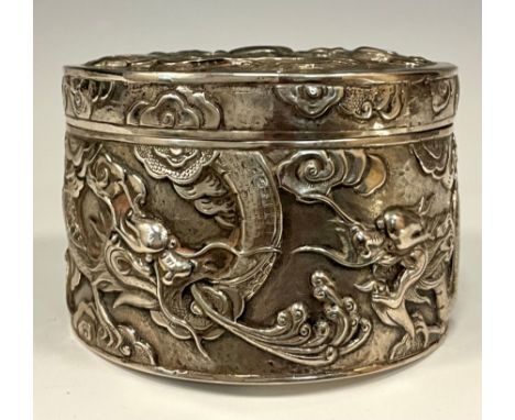 A Chinese silver embossed cache pot, decorated with Dragons chasing the Pearl of Wisdom, impressed character signature, 3.89o