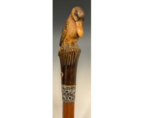 A carved handled walking stick, as a Fanciful Pelican, silver ferule, Malacca shaft, London 1892, 103cm long. 