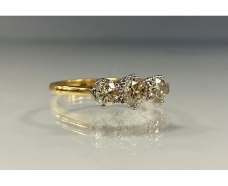 A certified diamond ring, set with three round brilliant cut diamonds, colour J-K, clarity SI1-SI2, total diamond weight 1.16