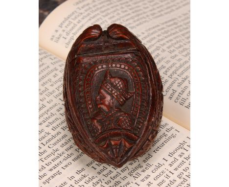 Snuff - a 19th century coquilla nut bugbear snuff box, carved as a novelty shoe, the cover carved with a courtier, 7cm long, 
