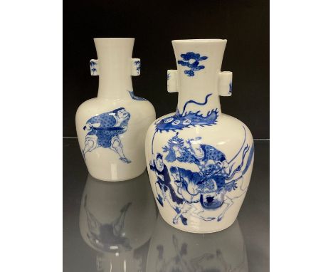 A pair of Chinese Kangxi type blue and white arrow vases, decorated in under glazed blue with depictions of warriors on horse