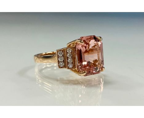 A certified pink tourmaline and diamond ring, octagonal step cut purply pink tourmaline, 5.21ct, between stepped shoulders se