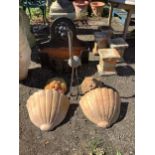 A bronzed metal stork garden ornament, a pair of terracotta lion mask wall appliqués and a pair of