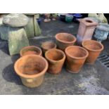 Twenty assorted terracotta planters, largest height 40cm, diameter 42cm, a terracotta pedestal,