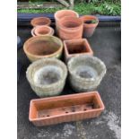 A group of twelve terracotta garden pots and planters and a pair of reconstituted stone garden