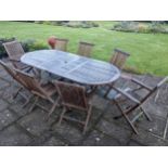 A Lindsay teak extending garden table and eight folding chairs. Condition - weathered, otherwise