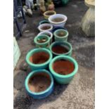 A collection of assorted glazed pottery garden pots and ornaments, largest diameter 42cm.