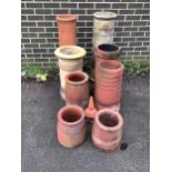 Eight assorted ceramic chimney pots and a finial, largest height 93cm. Condition - weathered