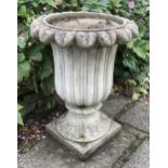 A pair of reconstituted stone tulip urns, height 66cm, depth 50cm, planting removed. Condition -