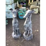A pair of black painted cast iron models of seated hounds, height 91cm. Condition - weathered