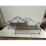 A pair of wrought iron garden benches, width 184cm, height 102cm. Condition - fair