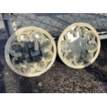 A pair of reconstituted stone wall mirrors of Gothic roundel form, diameter 44cm. Condition -