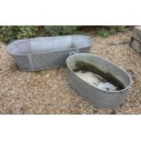 Two galvanised baths / tubs, 136cm and 104cm, planting removed, Condition - weathered otherwise