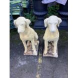 A pair of reconstituted stone models of seated hounds, height 70cm. Condition - fairly heavily