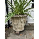 A pair of circular reconstituted stone garden urns, height 50cm, depth 60cm. planting removed.