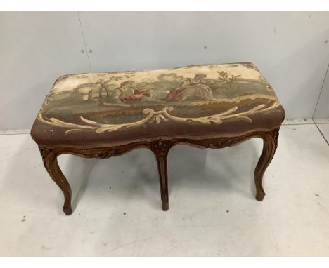 A French carved beech dressing stool, with an Aubusson style tapestry upholstered seat, width 88cm, height 46cm. Condition - 
