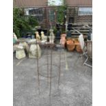 A wrought iron plant frame and eight hoops. Condition - rusted, otherwise good