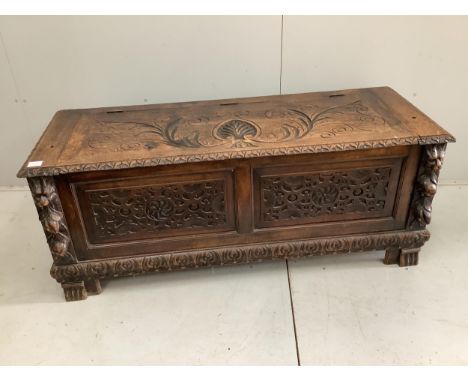 An early 20th century carved oak coffer formerly a monk's bench, width 137cm. Condition - lacking original arms and back, oth
