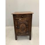 A Tudor style carved oak bedside cupboard, width 47cm, height 71cm. Condition - good