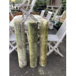 A set of three plain stone columns, diameter 15cm, height 96cm. Condition - weathered condition, one