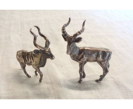 A pair of vintage South African hallmarked white metal antelope