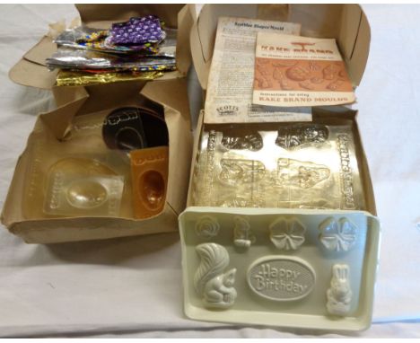 Two vintage boxed sets of Kake and Scotblock brand chocolate moulds including birthday and Easter eggs