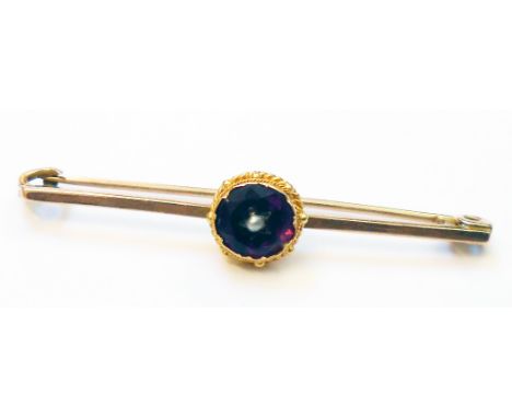 A Victorian 9ct. gold amethyst and seed pearl brooch - marked London made with small marks on back of brooch and "9" on round