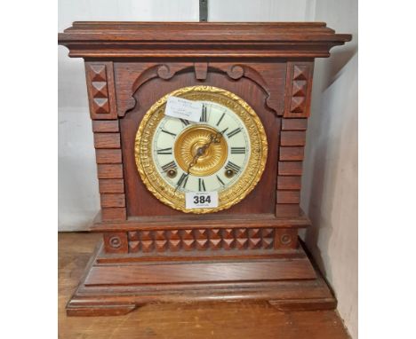 A late 19th Century stained oak cased American shelf clock with decorative dial, bezel and Ansonia gong striking movement - d