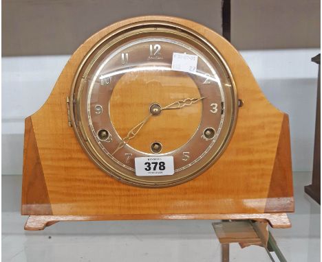 A vintage Bentima polished walnut and mixed wood cased mantel clock with eight day chiming movement