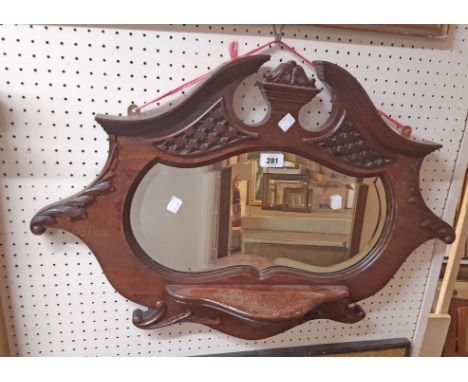 A 30" Edwardian mahogany framed wall mirror with shaped plate and shelf to front