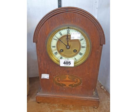 An Edwardian inlaid oak dome topped cased mantel clock with vase motif to front with Samuel Marti eight day gong striking mov